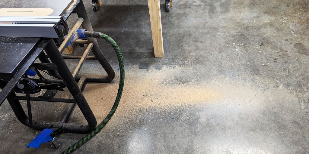 router table drawers cutting plywood with wood dust all over the floor